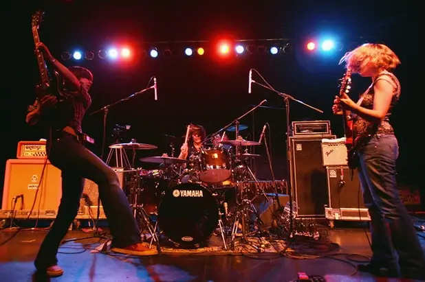 Carrie Brownstein, Janet Weiss and Corin Tucker of Sleater-Kinney performing in Los Feliz, California in 2005.